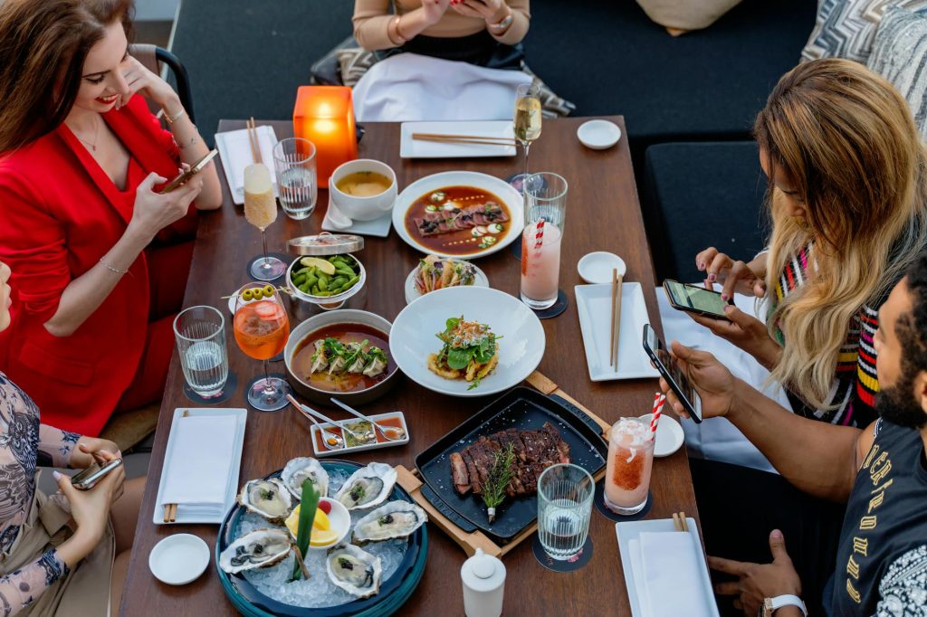 Friends enjoying a gourmet meal together in a Dubai restaurant.